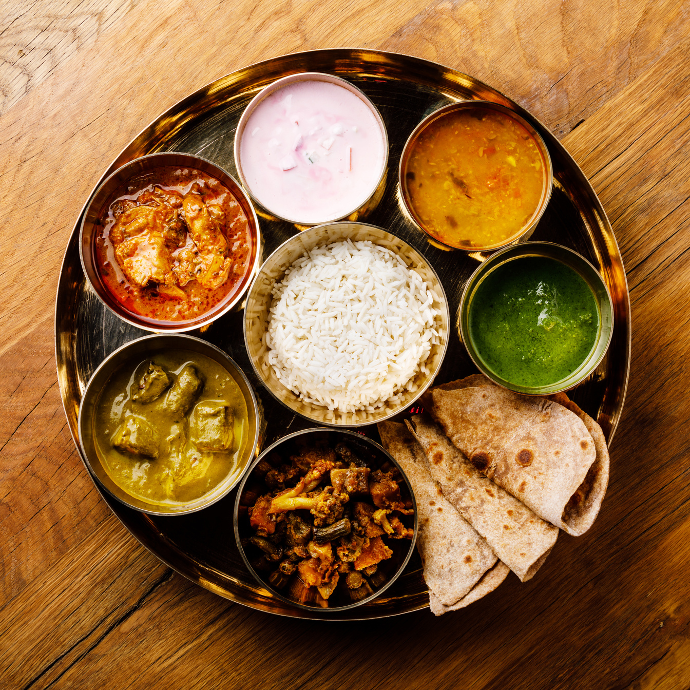 Indian food Thali Indian-style meal with chicken meat on wooden table